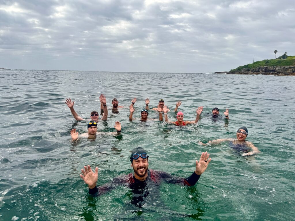 Swimly Ocean Saltwater Squad group swim in the crystal-clear waters of Sydney’s beaches.