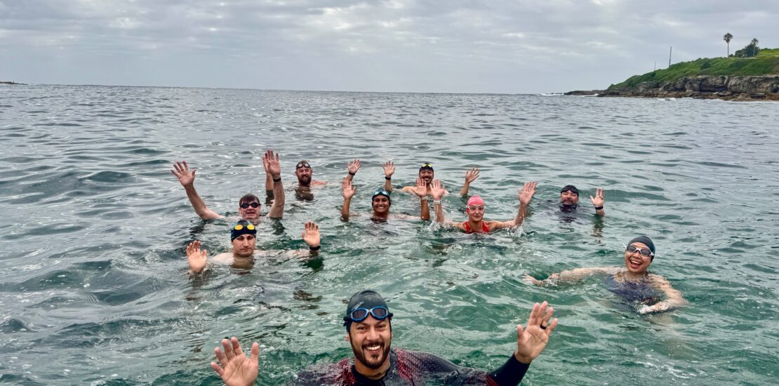Swimly Ocean Saltwater Squad group swim in the crystal-clear waters of Sydney’s beaches.
