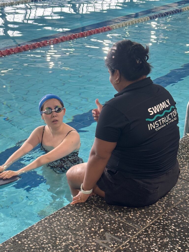 Swim instructor Antonette teaching an adult swimming lesson with calm support