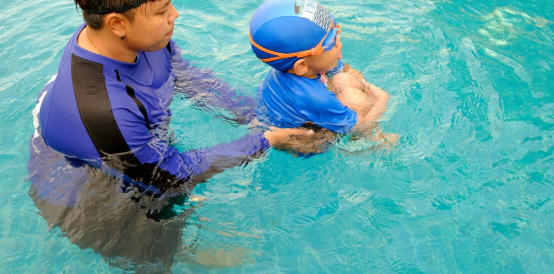 "Building water confidence — a child learns to swim with the guidance of an instructor."