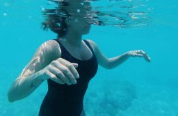 Woman underwater practising breath control during swimming session